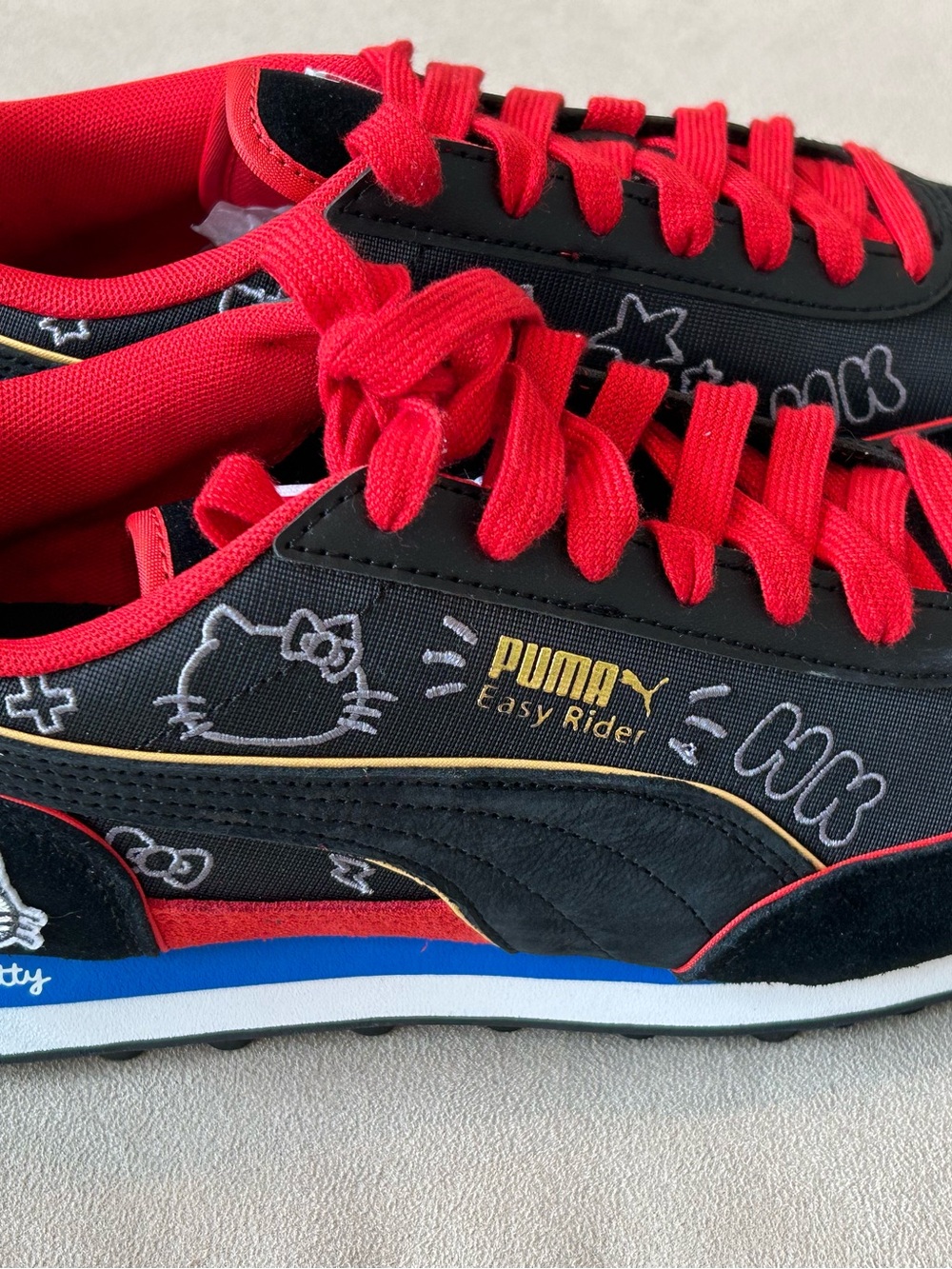 Puma Easy Rider Black with Red Accents and Blue Midsole Detail